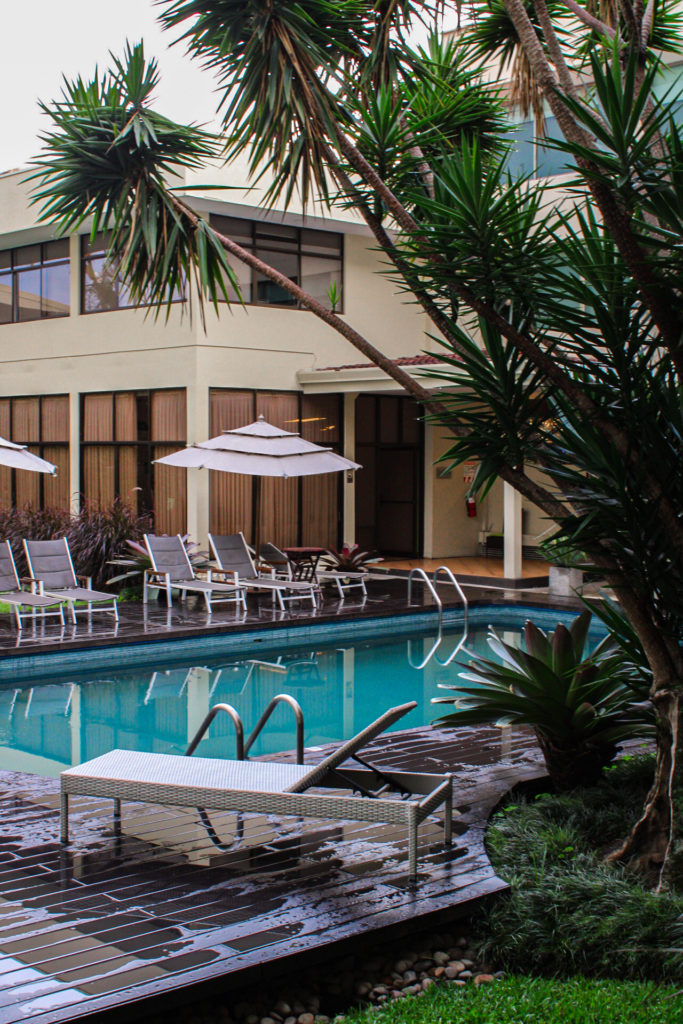 San Jose costa rica hotel pool and lounge chairs. Hotel Autentico in San Jose Costa Rica with palm trees.