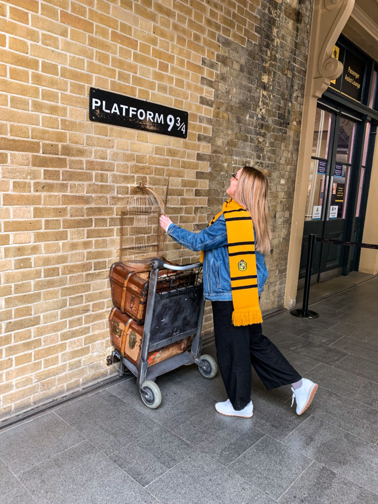 The Harry Potter Platform 9 3/4 display at King's Cross Station in London, England. Display with trolley, wand and sign.